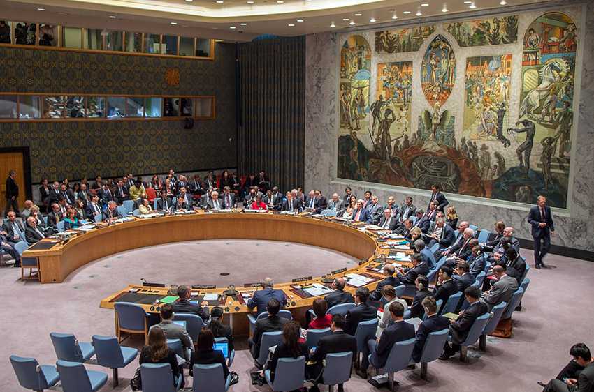 The Security Council meets on a long round table in a artfully decorated room